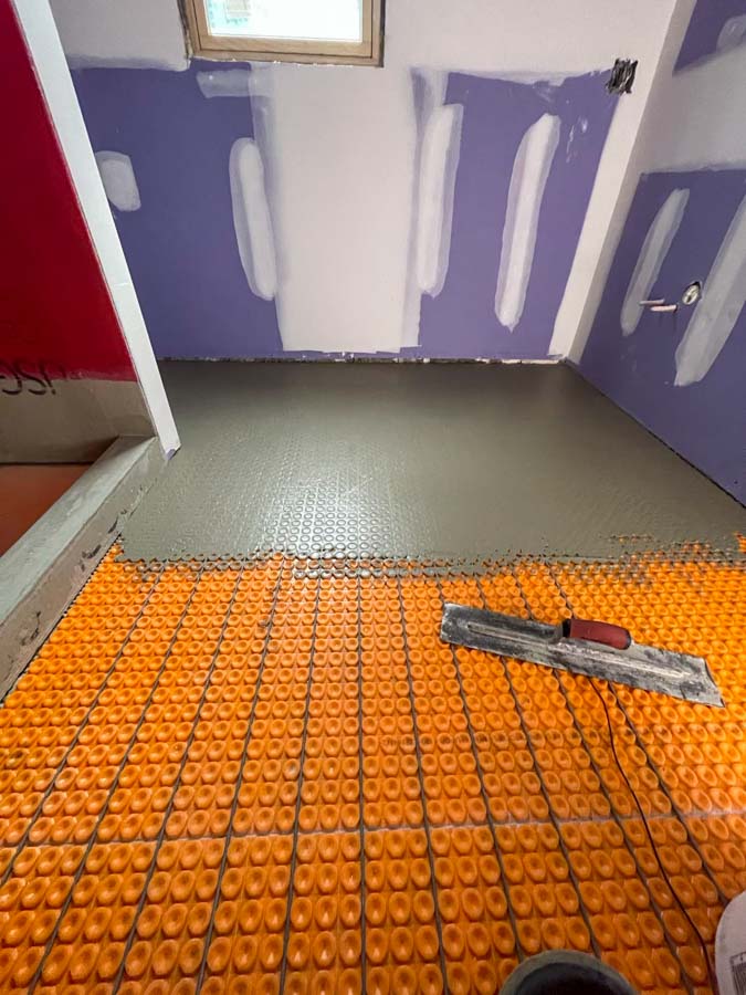 Prior to tile installation, heat mats are installed beneath the flooring