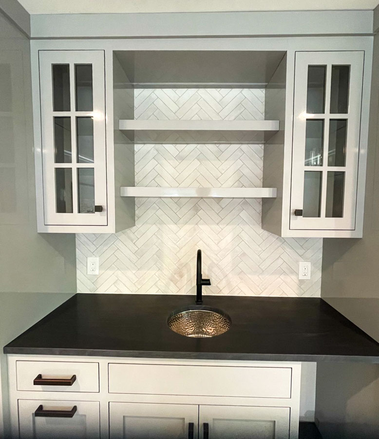 Ivory colored porcelain herringbone tiles for kitchen backsplash