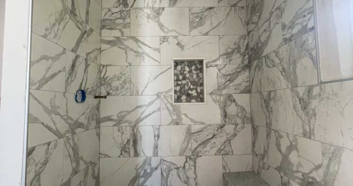 Bathroom wall made of porcelain tiles, same for the bench, and ceiling